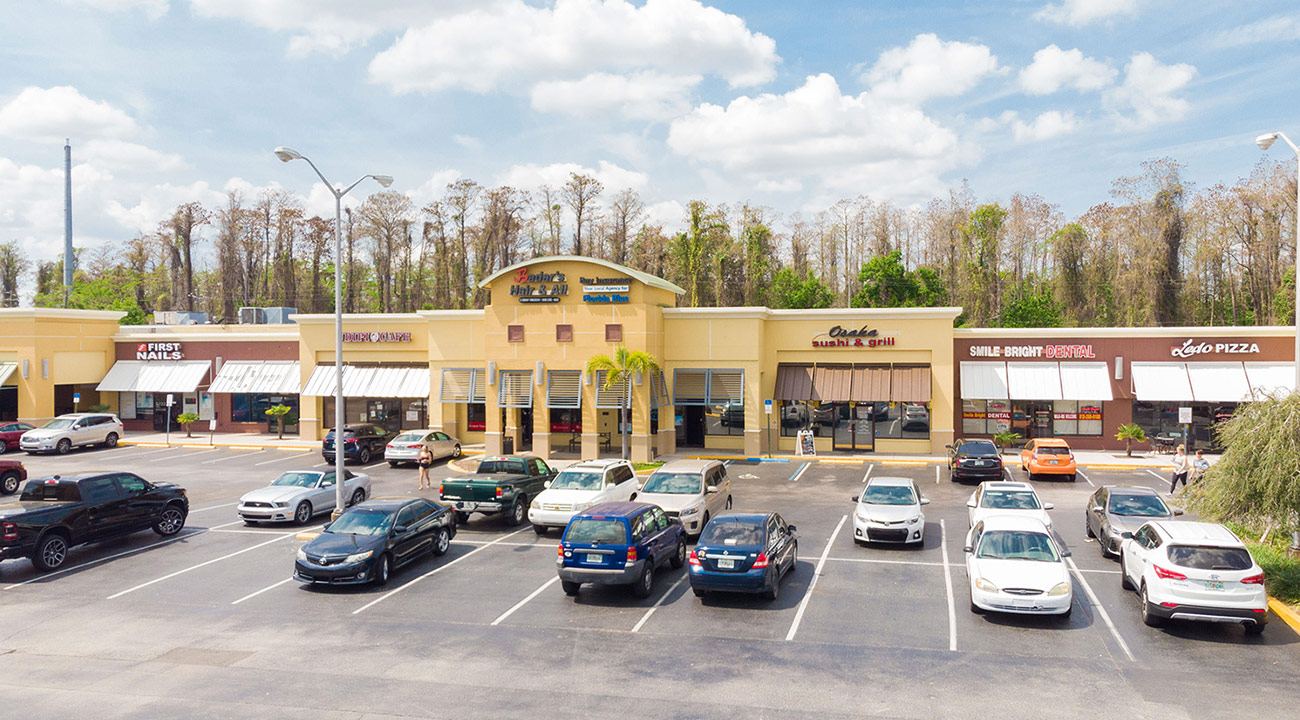 CS15 Colonial Square shopping center exterior with retail storefronts and parking lot in Tampa Florida