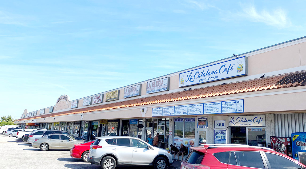 E3 Retail strip plaza exterior with café, local shops, and customer parking